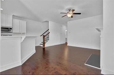 Unfurnished living room with dark wood finished fl