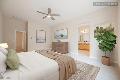 Bedroom with light carpet, connected bathroom, and
