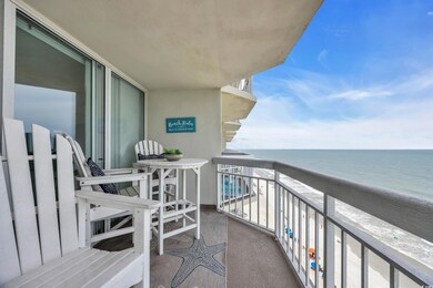 Balcony with view of water and beach