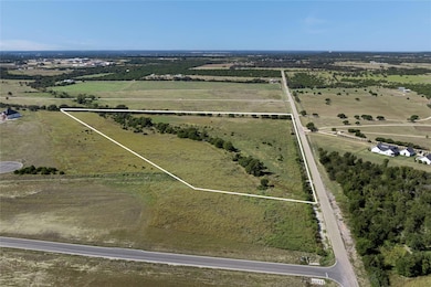 Aerial view of sparsely populated area with property parcel outlined