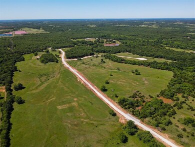 View of property location with a heavily wooded area