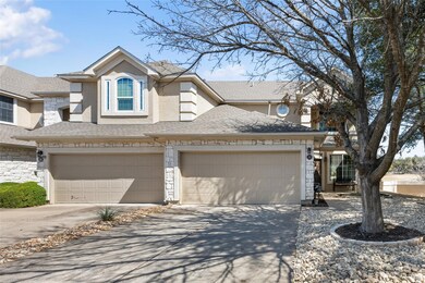View of front facade with an attached garage, dri