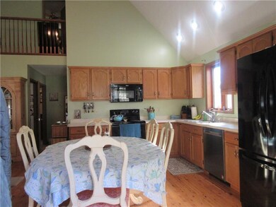 The eat-in kitchen boasts hardwood floors and rece