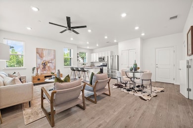 Living area with recessed lighting, light wood-style floors, and ceiling fan
