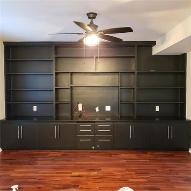 Family Room with wall of bookcases and storage