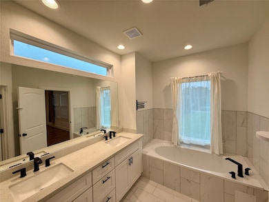 This primary bathroom features a modern design wit