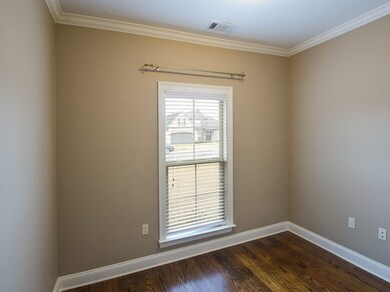 Located off the entry and separated from the bedroom areas is this private office/study.  This is a light,bright room with hardwood floors.