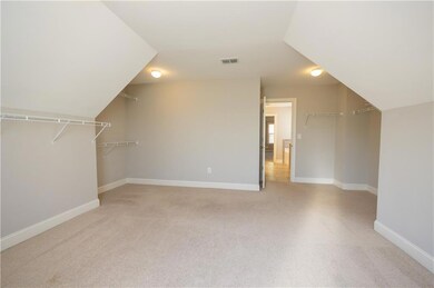 Bonus room with visible vents, light colored carpe