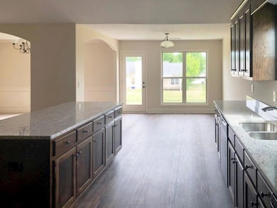 Kitchen with a sink, wood finished floors, and arc