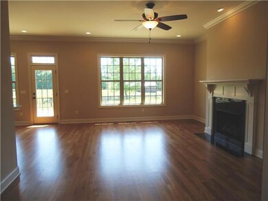 The foyer opens to the great room featuring 10 ft. ceilings, fireplace, sunny windows, recessed lighting and crown molding.