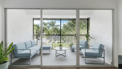 Very large tiled, screen enclosed balcony overlooking the pool area and canal from one side. Virtually Staged