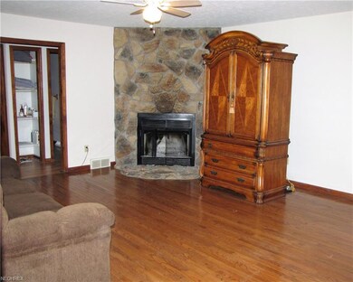 Stone fireplace with hardwood floor grace family r