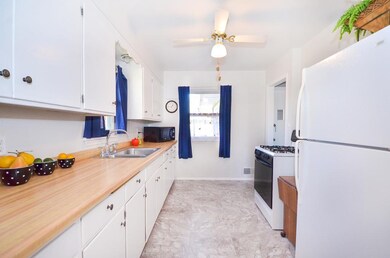 Bright and white kitchen with two windows, plenty 