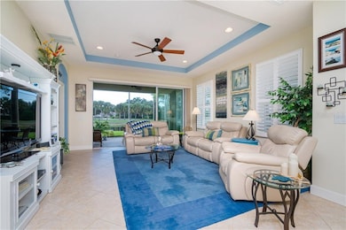 Great Room with Tray Ceilings and a view of water 