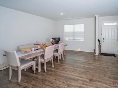 Dining space with crown molding, dark wood-style floors, and recessed lighting