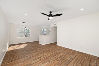 Unfurnished living room with ceiling fan, wood-type flooring, and sink