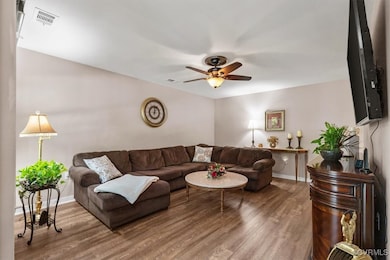 Living area featuring wood finished floors, basebo
