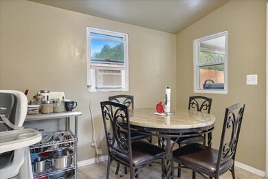 Dining space with cooling unit and vaulted ceiling