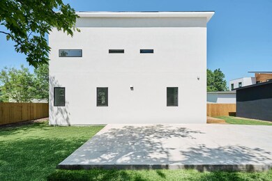 Rear view of property featuring stucco siding and