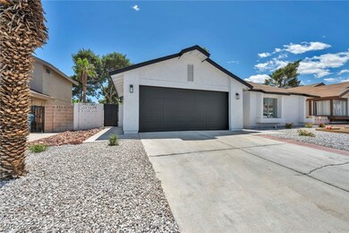 Ranch-style house featuring stucco siding, a garag