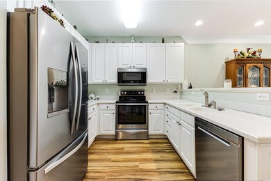 Kitchen with stainless steel appliances, a sink, l