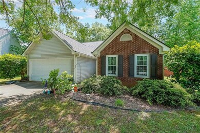 View of front of house featuring concrete driveway