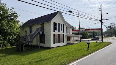 View of property exterior with stairs and a yard