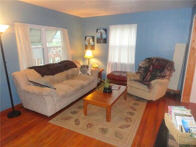 LIVINGROOM ENHANCED BY HARDWOOD FLOORS.