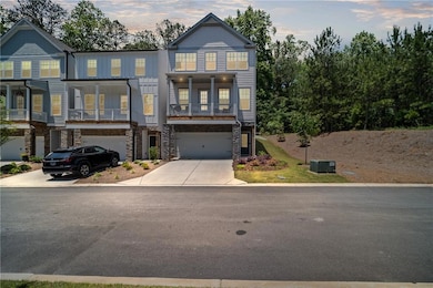 View of property with stone siding, driveway, an a