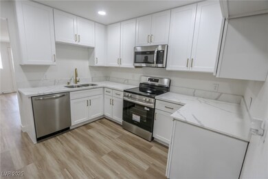 Kitchen featuring stainless steel appliances, a si