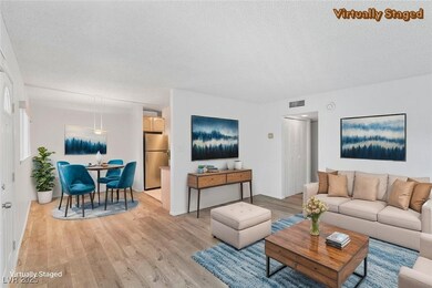 Living room with light wood-type flooring and a te