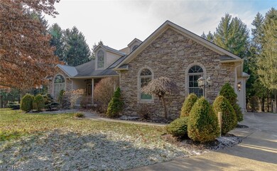 Curved and winding concrete driveway leads to side-entry double garage
