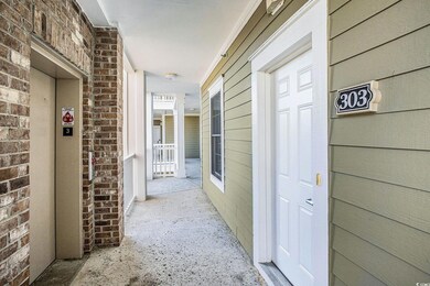 Hall featuring elevator and brick wall