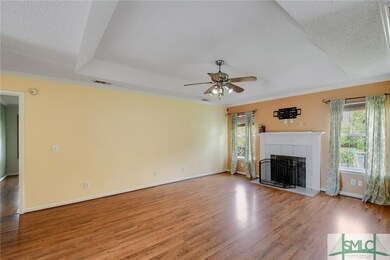 The great room features a recessed tray ceiling wi
