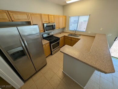 Kitchen featuring stainless steel appliances, a si
