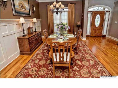 Serve your guests in the warm and inviting formal dining room with wanscoting panels and beautiful hardwood floors.