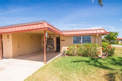 Carport with outside laundry room.