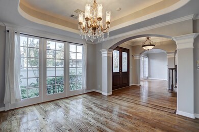 As you enter the grand front Entry you are flanked by the Formal Dining Room (here) and the Formal Living Room on the other side, creating a create open flowing floorplan. Natural light cascades abundantly thru the wall of French Windows across the front of the home! Beautiful!