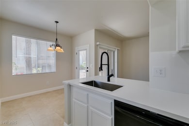 Kitchen featuring a sink, black dishwasher, white