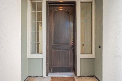 Tucked beneath a graceful archway, the front door