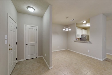 Foyer entrance with light tile patterned floors, a