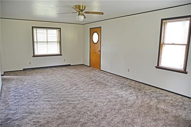 The spacious living room and the doorway leads to 