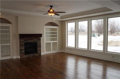 Stone fireplace flanked by bookcases in the Great 