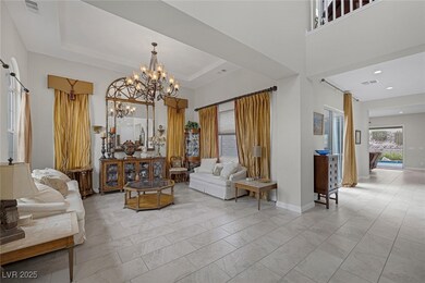 Living area featuring a tray ceiling and a notable