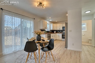 Dining space with light wood-style flooring, recessed lighting, and plenty of natural light