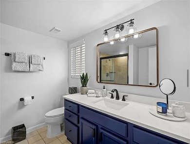 Bathroom with tile patterned flooring, visible ven