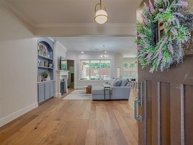 Spacious Foyer to great guest giving you a beautiful craftsman front door, designer lighting, modern baseboards and wood flooring.