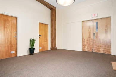 Lobby outside unit. Unit is Middle Door. Double Door on right is toward outside Hall door