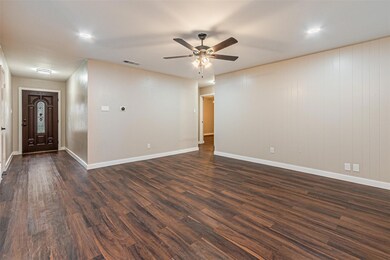 Unfurnished room with a ceiling fan, dark wood-sty