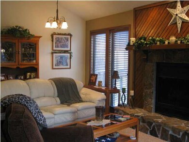 WARM AND INVITING, THE LIVING ROOM HAS SOARING BEA